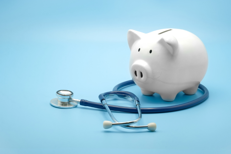 A stock image of a piggy bank and a stethoscope.